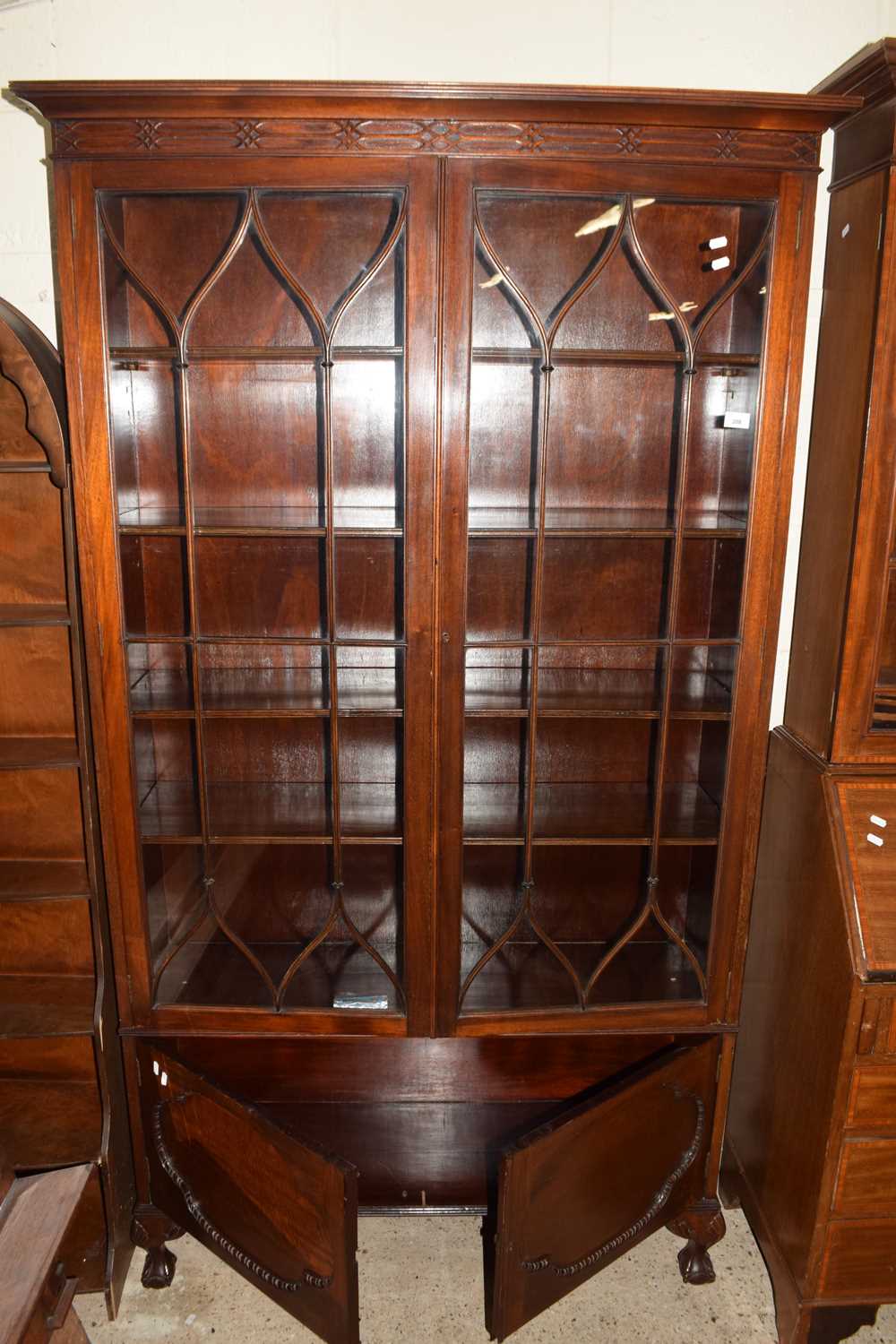 Early 20th Century mahogany bookcase cabinet with glazed top section and cupboard base, raised on