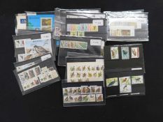 Packet: Assorted modern mint and used world stamps on stock cards plus a few covers