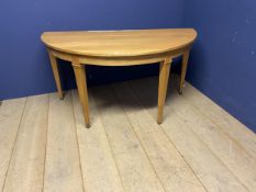 A modern light oak style demi lune console table, 150cm wide