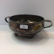 Electro plated nickel silver bowl with loop handles and beaten decoration on 4 scrolling feet