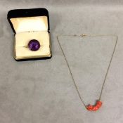 Coral pendant on a yellow metal chain and an Amethyst ring set in yellow metal surround stamped 18