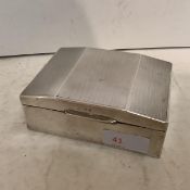 A hallmarked silver cigarette box, some minor dents