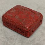 An enamelled scabbarded style oriental box raised on 4 circular feet 9x8x4cm