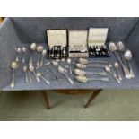 A quantity of silver and plate to including hallmarked silver spoons, some cased