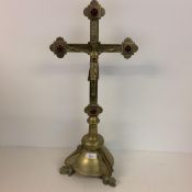 A table top crucifix on stand, with cabochon glass to each finial, 57cm high approx., x 26cm wide