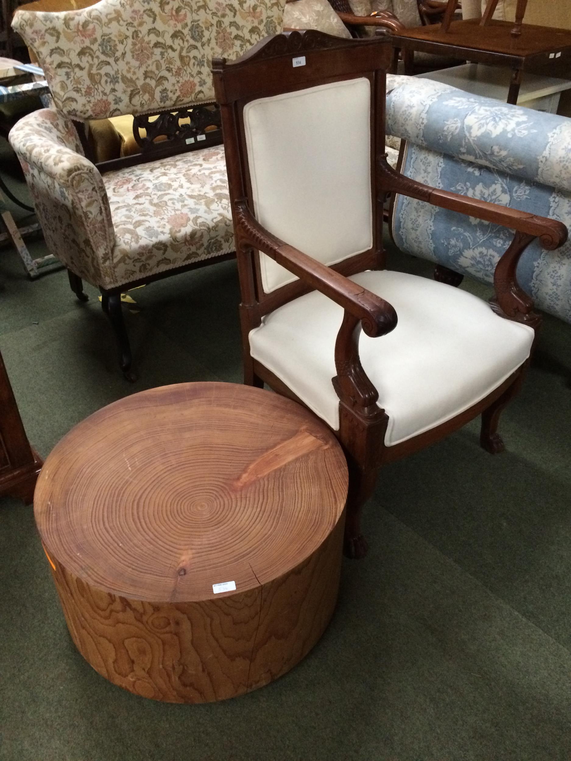 Large wooden and cream upholstered arm chair, and a table/stool as a plank of circular wood