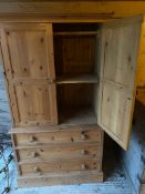 Modern pine wardrobe with 3 drawers below 2 cupboard doors, to hanging rail and central shelf, 92