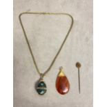 Banded agate chain, and a gilt and paste enamel egg, and a stick pin