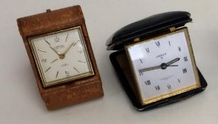 2 travel alarm clocks, one by Luxor, retailed by Garrard & CO, and a leather cased 8 day travel