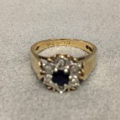 9 ct gold sapphire and diamond ring central circular cut sapphire with a surround of single cut