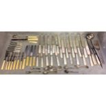 A large quantity of flatware, including bone handled knives and forks etc and knife rests