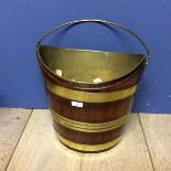 Mahogany and brass bound peat bucket with handle, and with inset brass bucket