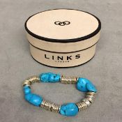 Turquoise and white metal bracelet on elasticated strap