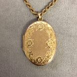 9 ct gold rope twist necklace with a 9ct gold oval picture locket with engraved decoration 12g