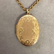 9 ct gold rope twist necklace with a 9ct gold oval picture locket with engraved decoration 12g