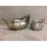 A two piece sterling silver tea set,the teapot and sugar with half reeded design, Chester, 1899,
