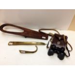 A long brass shoe horn, and a short one, a mahogany boot jack, a pair of Vintage binoculars in