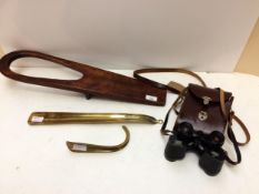 A long brass shoe horn, and a short one, a mahogany boot jack, a pair of Vintage binoculars in