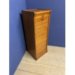 A vintage honey coloured oak tambour fronted cabinet