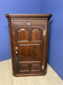 Large oak hanging corner cupboard, with brass plates and handle129h x 86 w x 48 d cm