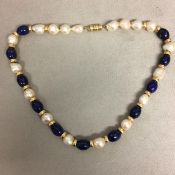 Baroque Pearl and lapis necklace strand on a 14ct gold clasp, 40cm
