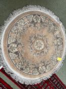 Chinese wash style circular rug with soft pink and grey floral designs 127cm diameter