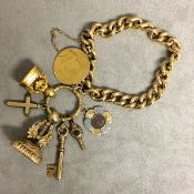 15ct gold flat curb link charm bracelet with spade guinea, 2 gilt metal watch fobs, 9 ct cross and 2
