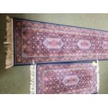 Rugs: Red ground runner with blue borders and geometric designs, and a similar smaller Runner 269