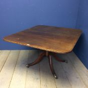 Mahogany rectangular breakfast table on quatrefoil base, with cast lions paw feet and castors, 112 x