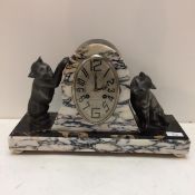 A French slate and marble mantle clock, in the Art Deco taste, the oval dial marked 108-110 Rue