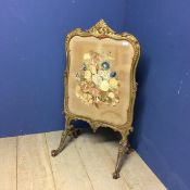 Victorian fire screen, a floral tapestry beneath a glazed front, and with a decorative carved