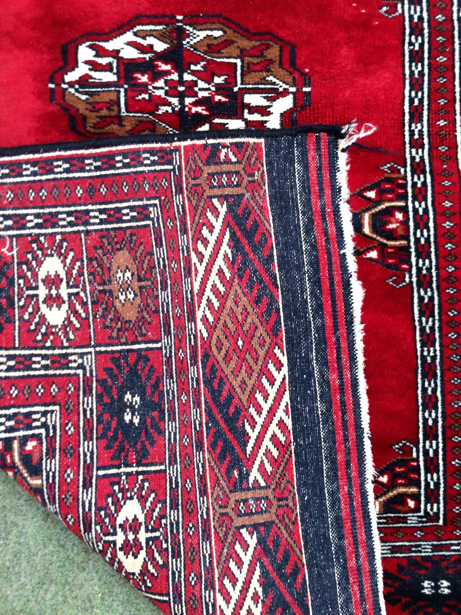 4 rugs, 3 red ground rugs with all over geometric stylized designs, and a blue and red ground Tree - Image 4 of 9