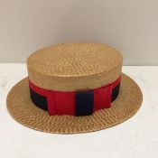A straw boater/hat, the inside lining labelled Showerproof, Battersby & Co London, with Red and Navy