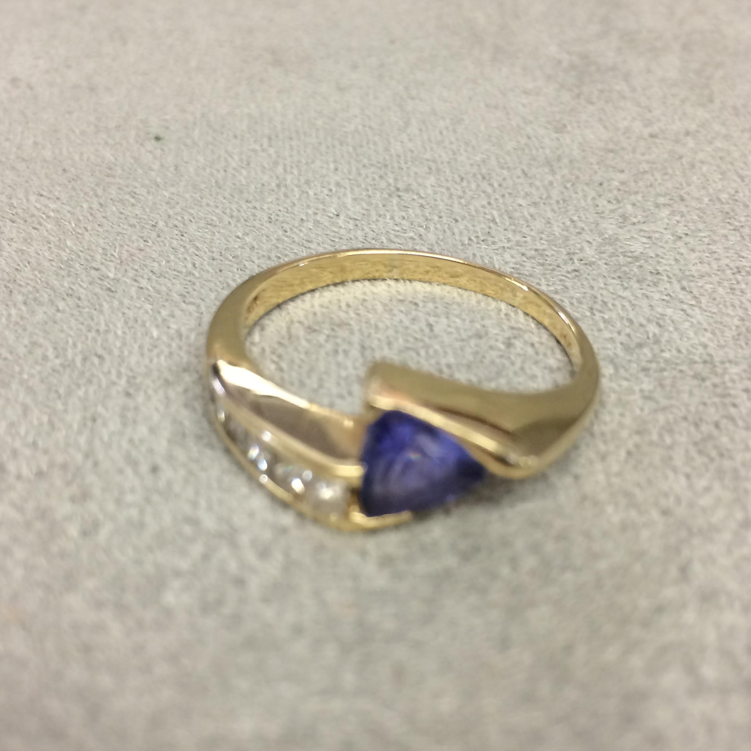 14k gold Tanzanite and diamond ring, central free cut tanzanite with square channel set diamonds