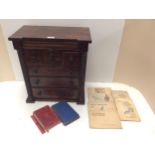 A Scottish, oak Apprentice cabinet/specimen 7 drawer cabinet, and a quantity of cigarette cards