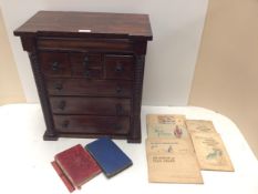A Scottish, oak Apprentice cabinet/specimen 7 drawer cabinet, and a quantity of cigarette cards