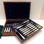 A good cased set of Sterling silver fish knives and forks and servers, with mother of pearl handles,