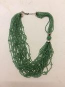 Jade necklace, C20th, 3 strands of Jade (type 3) beaded multistrand necklace, in a Shanghai Tang