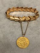 Unmarked yellow metal bracelet with 1911 George V gold sovereign, 29.7g