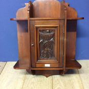 Mahogany hanging cupboard, with raised carved floral panel to front