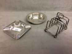 Two sterling silver ashtrays together with a sterling silver toast rack, various dates and makers,