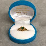 An Egyptian yellow metal and emerald ring marked 15ct 3.1g, size O