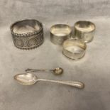 A collection of sterling silver items to include a buckle bracelet, napkin ring and other items