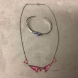 A platinon and pink topaz necklace and a white metal and enamel bangle bracelet, boxed