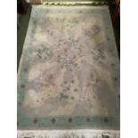 A Chinese wash Oriental style rug, with blue ground and parrots and oriental birds, 168 x 253cm