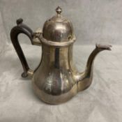 A sterling silver coffee pot of bulbous form on circular base, Goldsmiths Silversmiths Company