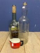 Haigs water into whiskey jug, and a large Martel bottle and a large Bells Scotch Whisky bottle,