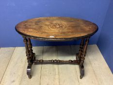 An oval mahogany and inlaid side table with turned stretcher to base, 70cm W