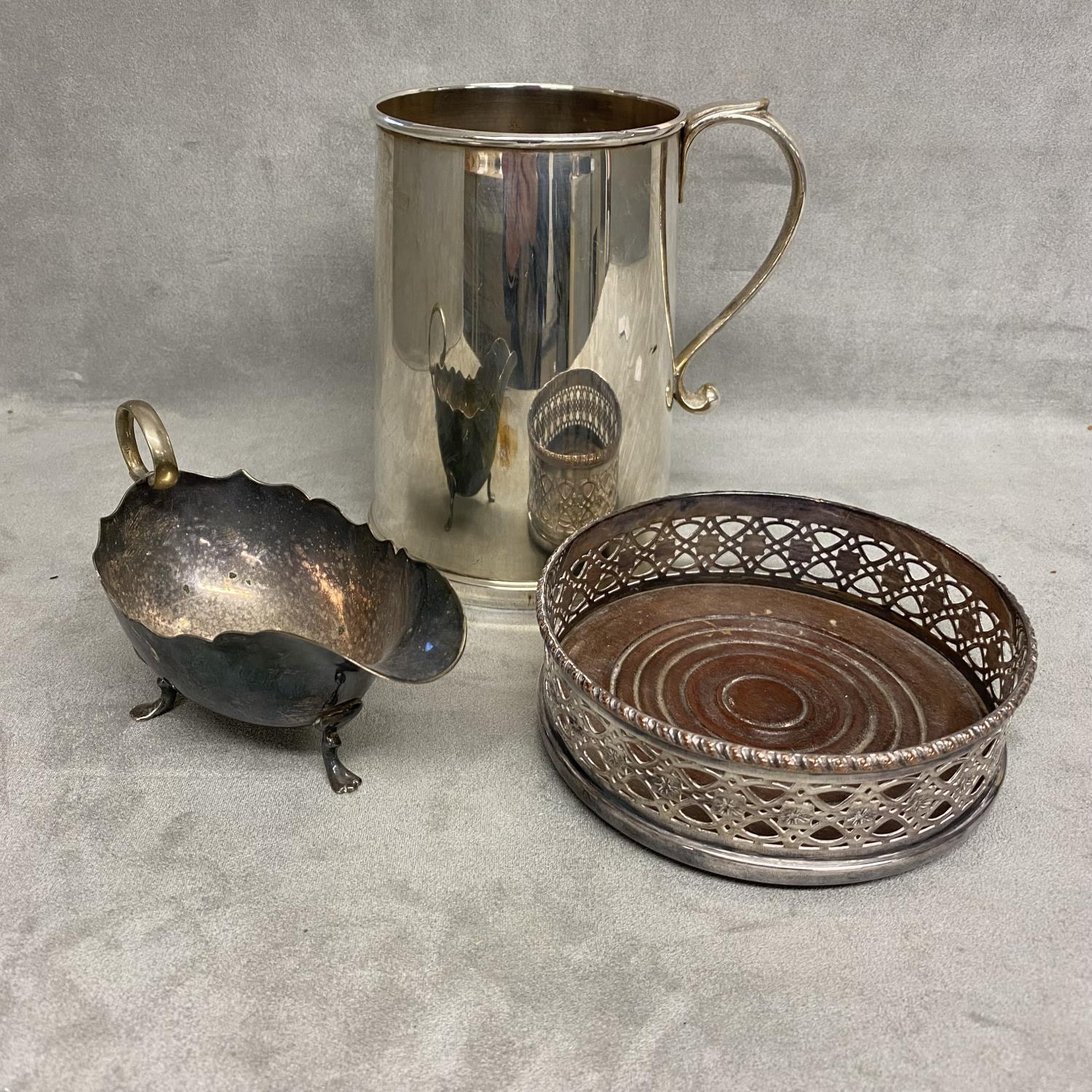 Three items of silver plated wares to include sauceboat, wine coaster and large mug