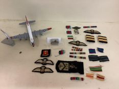 Quantity of Militaria cloth ribbons and badges and a lighter from QEII
